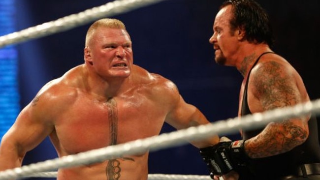 Brock Lesnar wrestles The Undertaker in the WWE.