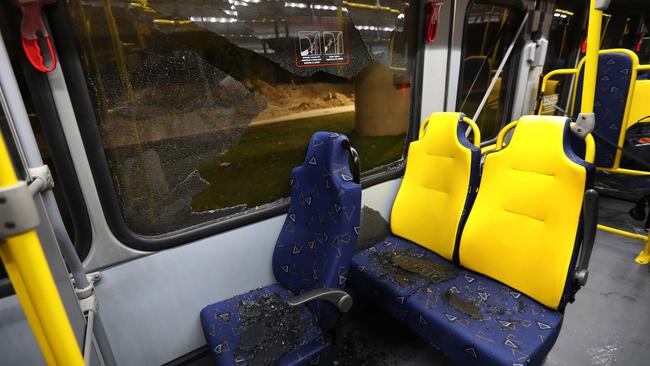 Shattered glass lies on the seats of a media bus in the Deodoro area of Rio de Janeiro.