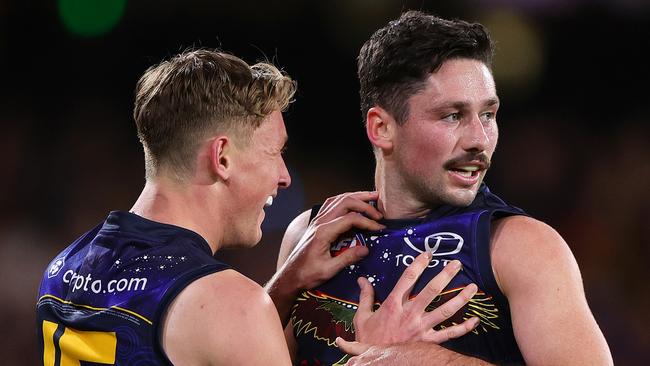 ADELAIDE, AUSTRALIA - MAY 26: Chayce Jones of the Crows celebrates a goal with Brayden Cook during the 2024 AFL Round 11 match between Kuwarna (Adelaide Crows) and Waalitj Marawar (West Coast Eagles) at Adelaide Oval on May 26, 2024 in Adelaide, Australia. (Photo by Sarah Reed/AFL Photos via Getty Images)