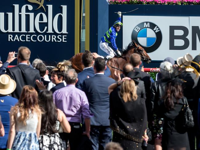 The crowd soaks up Nick Hall’s whip-waving performance as Jamenka easily takes out the Caulfied Cup. Picture: Mark Dadswell