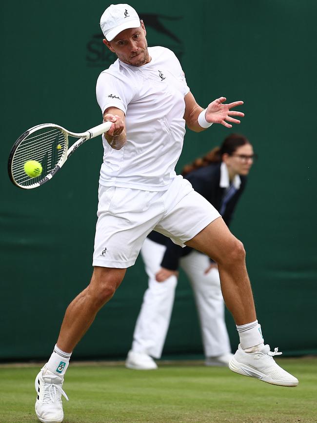 Australia's James Duckworth returns against Australia's Alex De Minaur.