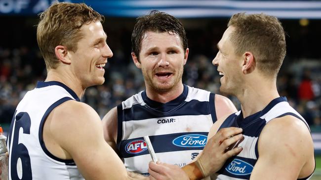 Joel Selwood celebrates with brother Scott Selwood and Patrick Dangerfield. (Photo by Adam Trafford/AFL Media/Getty Images)