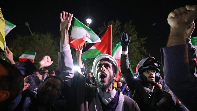 Demonstrators wave Iranian and Palestinian flags in front of the British Embassy in Tehran after Iran launched a drone and missile attack on Israel. Picture: AFP