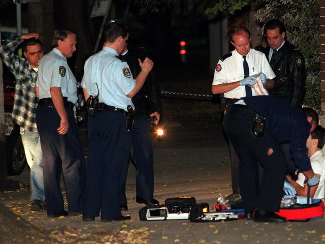 Police and paramedics helping Mr Toumazis’ friend Nicholas Lambos, who initially hadn’t realised he’d been shot by Hamzy. Picture: Glenn Dickerson