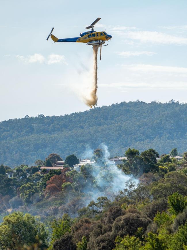 Multiple units from the Tasmanian Fire Service and Tasmania Police battled a large grass fire at Herdsmans Cove and spot fires at Bridgewater, with water bombing aircraft dousing the flames. Photo: Rory Jones