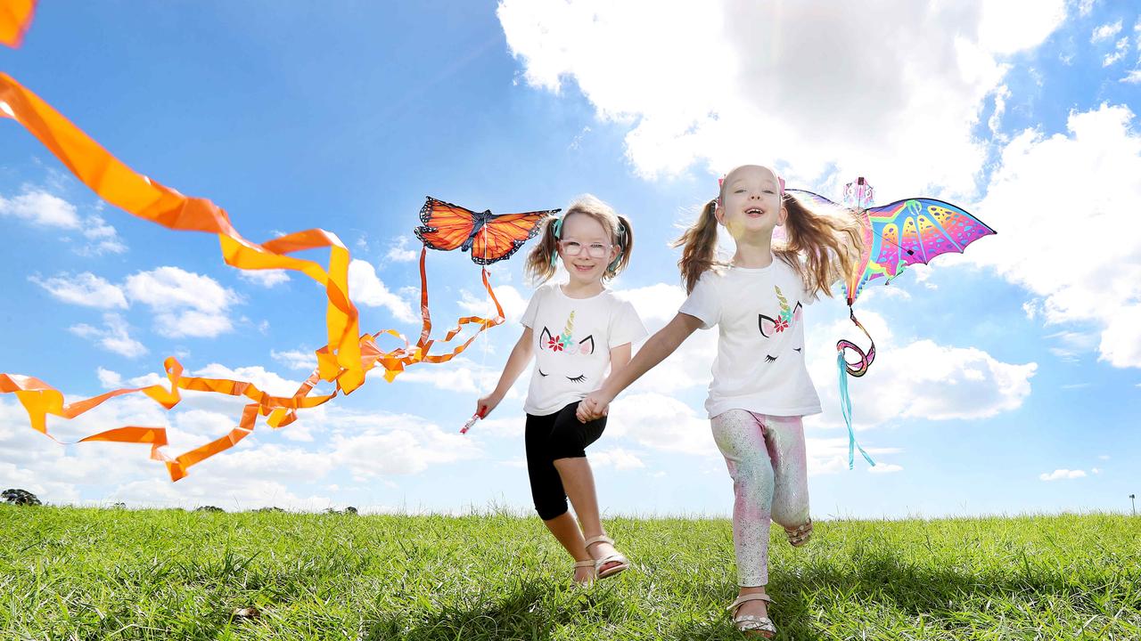 Sisters Lara Kennedy, 5, and Lucy Kennedy, 6, getting excited for the Brisbane Kite Festival. Wynnum is known for its water views and festivals. Picture: Tara Croser