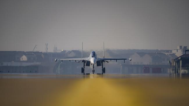 A J-16 air fighter waits to take off on the runway at a training base of PLA's naval aviation force in Ningbo in east China's Zhejiang province. Picture: Getty Images.