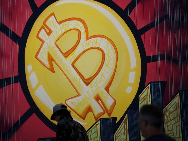 (FILES) In this file photo taken on June 4, 2021 a banner (designed by artists  Stacey Coon, Anastasia Sultzer, and Nanu Berk) with the logo of bitcoin is seen during the crypto-currency conference Bitcoin 2021 Convention at the Mana Convention Center in Miami, Florida. - Investing in bitcoin and other digital currencies remains a risky game where the rules could change significantly, but the payoff could be big. (Photo by Marco BELLO / AFP)