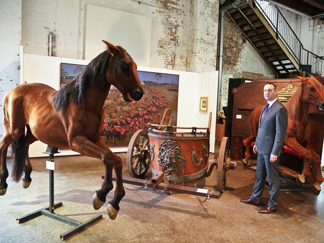 John Keats from Sotheby's Australia stands with props from the film Gladiator owned by actor Russell Crowe. Picture: AAP