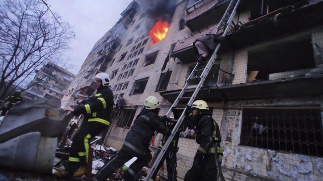 A woman escapes the burning building after the attack in Kyiv. Picture: State Emergency Service of Ukraine