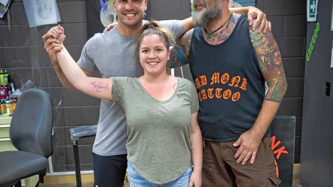 Mega footy star takes Mackay fan to get signature inked | The Courier Mail