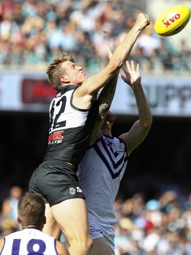 om Jonas punches the ball away against Fremantle. Picture Sarah Reed