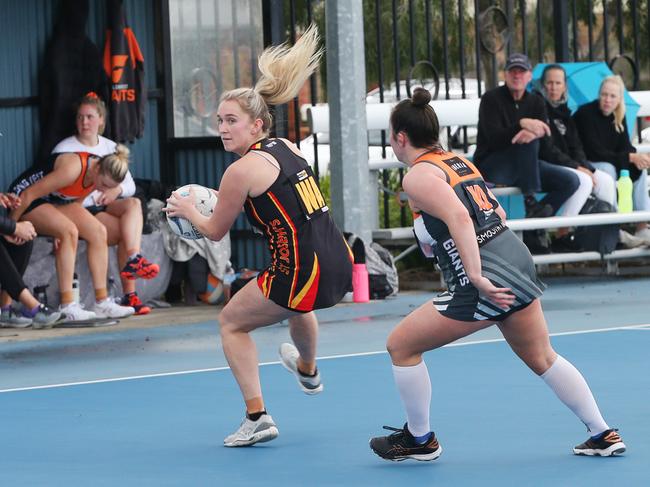 St Joseph's Zoe Cowan makes a grab in front of Giants Meg Matthews. Picture: Alan Barber