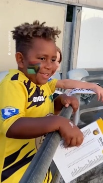 Aussie football players help adopted boy