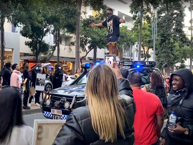 A protester challenging police in South Brisbane before jumping on top of the vehicle during Black Lives Matter protest rally in Brisbane. Picture: Supplied