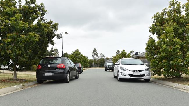 Vehicles parked opposite one another with all wheels on the road on Denham Crescent in North Lakes. Picture: Marcel Baum