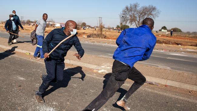 A community member beats a person suspected of looting in Johannesburg. Picture: Getty Images