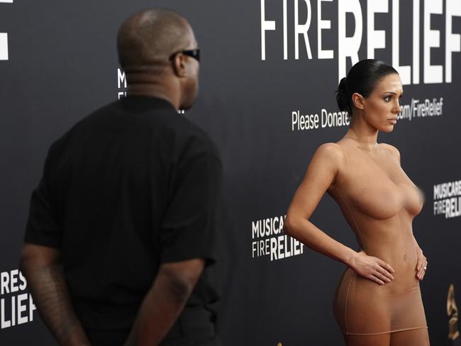 Kanye West looks on as his wife Bianca Censori hits the red carpet in a nude dress. Picture: /AP