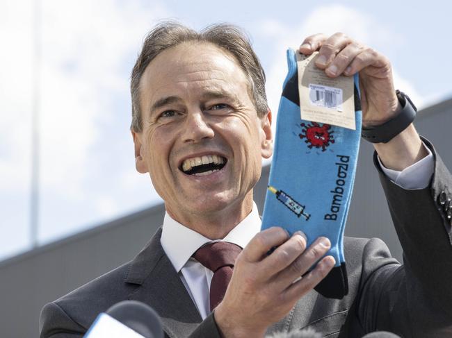 Greg Hunt with a pair of COVID socks, during the first vaccination in the ACT. Picture: NCA NewsWire/Gary Ramage