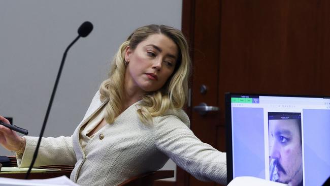 Amber Heard listens to her ex-husband, Johnny Depp, during his defamation trial against her. Picture: AFP