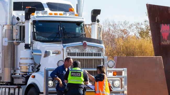 A road train and its safety vehicle were the first to be stopped by NT Police at the NT/SA border after new NT entry restrictions came into effect at 4pm yesteday. Picture: Emma Murray