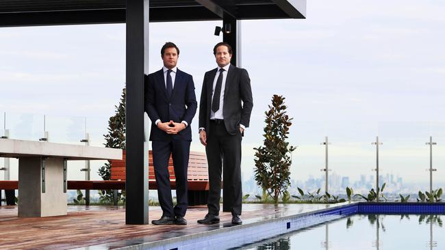 Developers Jonathan and Will Deague on the pool deck of the Whitehorse Towers apartment complex in Box Hill. Picture: Aaron Francis