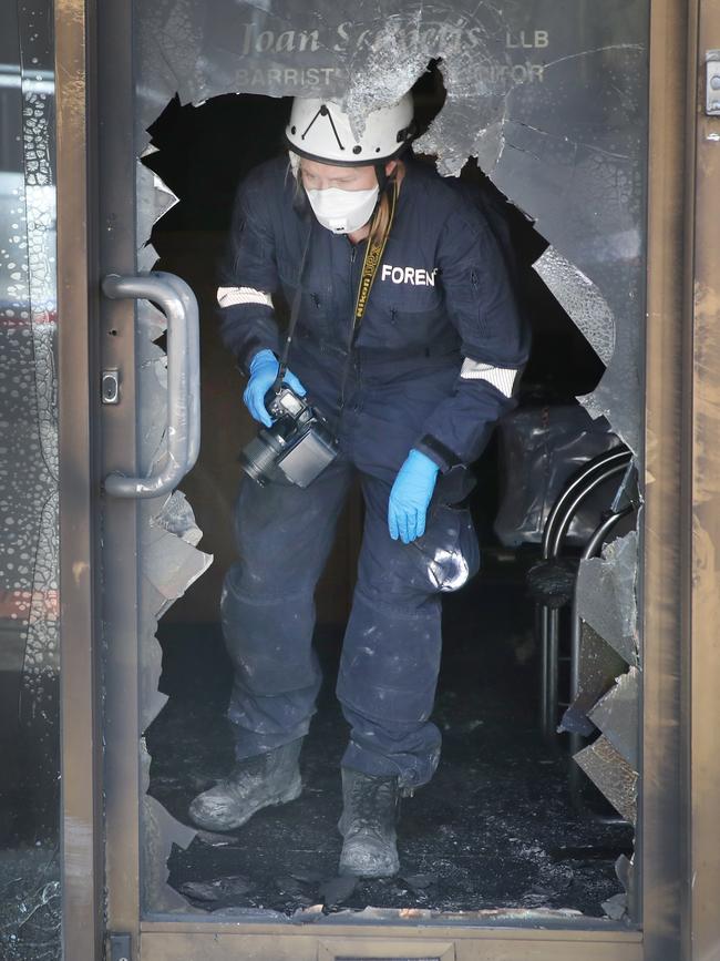 Police inspect a firebombed tobacco shop in Oakleigh. Picture: David Crosling