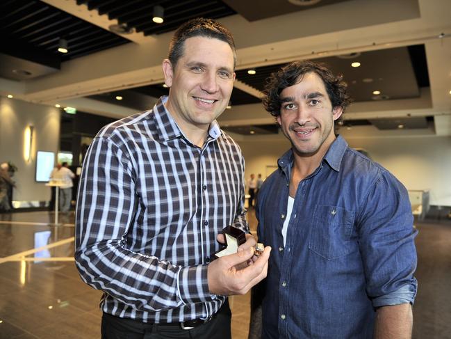 Johnathan Thurston (R) receive an exact replacement of the NRL premiership ring he gave up to Steve Price.