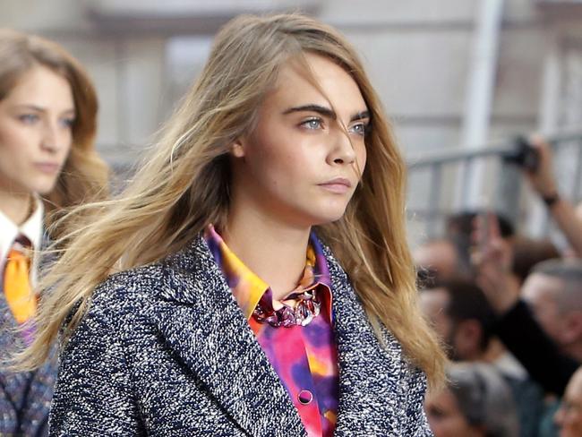 Model Cara Delavingne, right, and other models wear creations as part of Chanel's Spring/Summer 2015 ready-to-wear fashion collection presented in Paris, France, Tuesday, Sept. 30, 2014. (AP Photo/Thibault Camus)