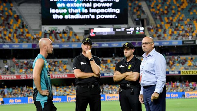 Brisbane Heat captain Chris Lynn (left) talks to match officials on Thursday night. Picture: AAP 