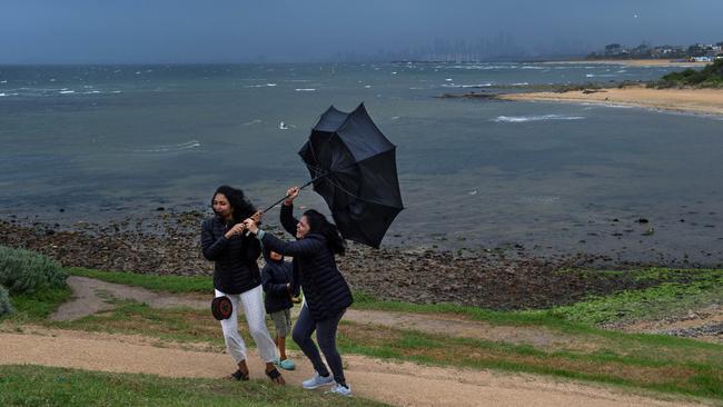 People run for cover as a storm approaches Melbourne. Picture: Nicki Connolly