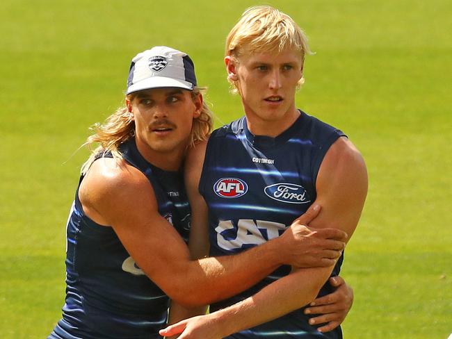 Bailey Smith gives Mitch Knevitt a hug at Geelong Cats training. Picture: Alison Wynd