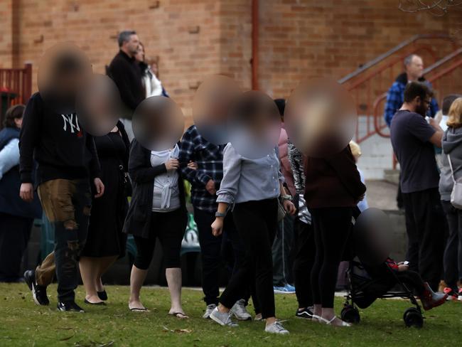 DAILY TELEGRAPH JULY 11, 2024. ***WARNING FACES MUST BE BLURED**,  The mother (In black and grey) and her family arrive to join community members at Chifley Park in Lalor Park to mourn the children killed in the recent house fire on the same street. Picture: Jonathan Ng