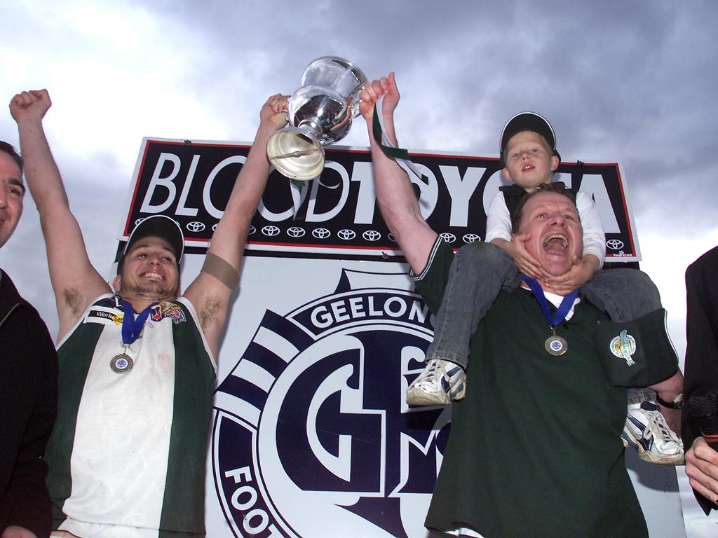 Captain Sam Talarico and coach Ken Hinkley with his son Jordan. celebrate Bell Park's against the odds premiership win over St Mary's at Skilled Stadium in 2003.