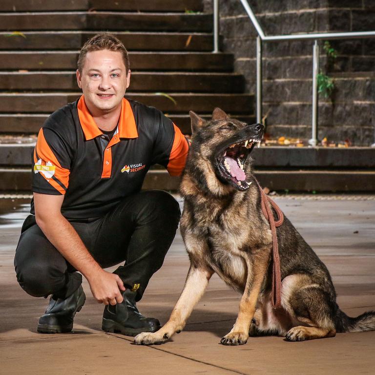 Adam Sikyr with guard dog Jumbo wo is on patrol at the Zuccoli IGA. Picture: Glenn Campbell