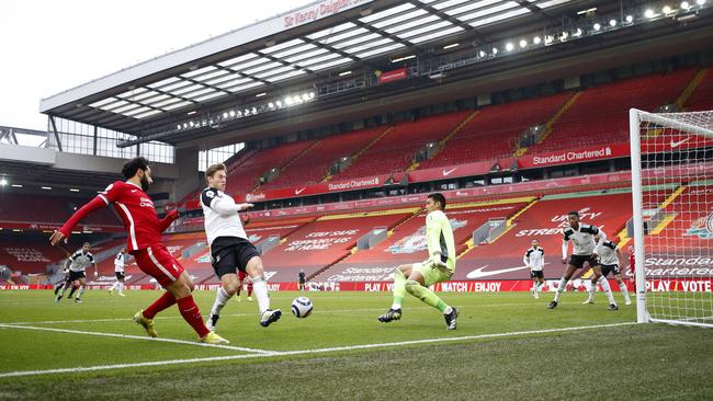 Mohamed Salah crosses the ball under pressure from Joachim Andersen and Alphonse Areola during the Premier League match between Liverpool and Fulham at Anfield. (Photo by Phil Noble – Pool/Getty Images)