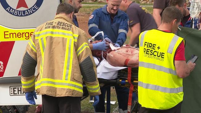 A man is loaded into the back of an ambulance. Picture: NV