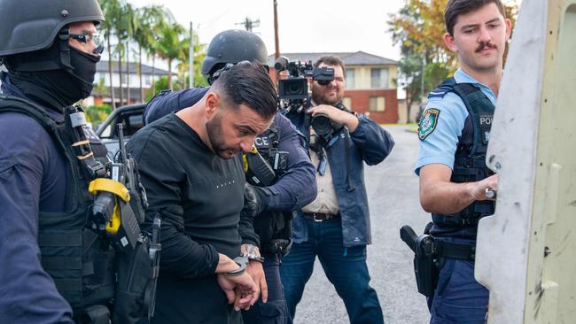 Boulos is loaded into a NSW Police vehicle before being taken to Bankstown Police Station. Picture: Thomas Lisson