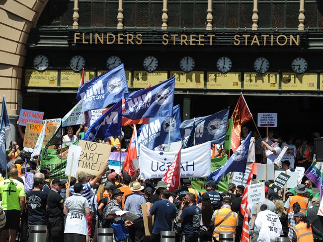 Public transport staff hold a stop-work meeting outside Flinders Street Station. Picture: Andrew Henshaw