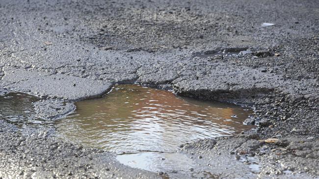 Pot holes on the corner of Marmaduke and George streets, Burwood. Picture: Craig Wilson