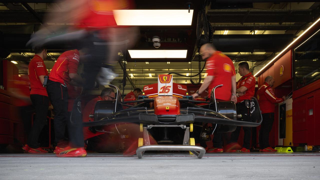 Ferrari go to work on the car of Charles Leclerc. (Photo by Andrej ISAKOVIC / AFP)