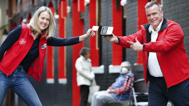 Salvation Army workers Major Brendan Nottle and Tameka Buckley with a Salvos eftpos donation reader for the Red Shield Appeal. Picture: David Caird