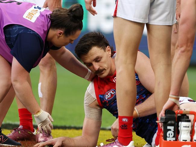 Jake Lever of the Demons is assisted off the field under concussion protocols in Perth. Picture: Will Russell/AFL Photos via Getty Images.