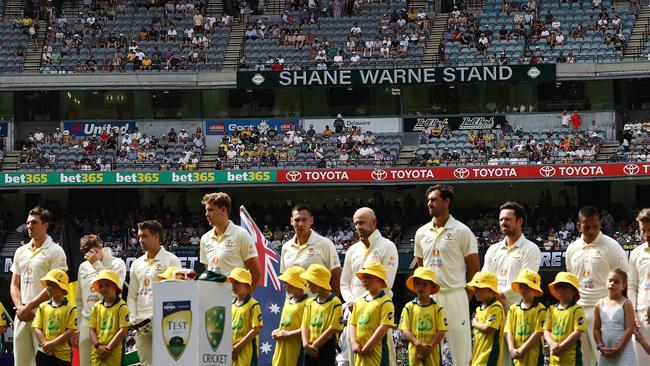 The Australians line up for the national anthem in front of the Shane Warne Stand . Picture by Michael Klein