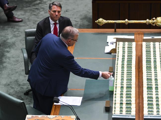 Australian Opposition Leader Anthony Albanese uses hand sanitiser as he attends a parliamentary sitting under rules of social distancing. Picture: AAP