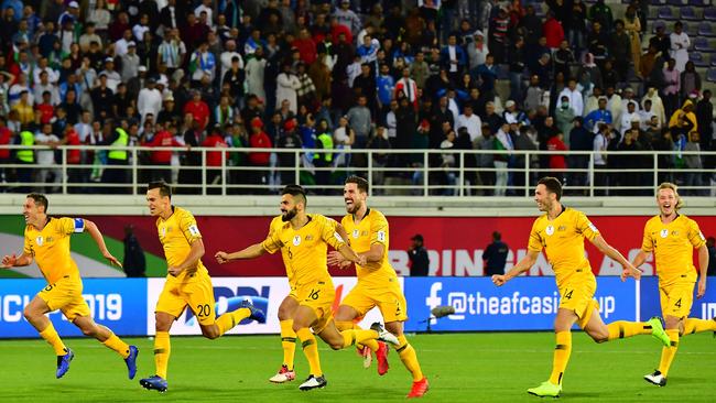 Socceroos players celebrate their victory over Uzbekistan at the Khalifa bin Zayed Stadium in Al-Ain. Picture: AFP