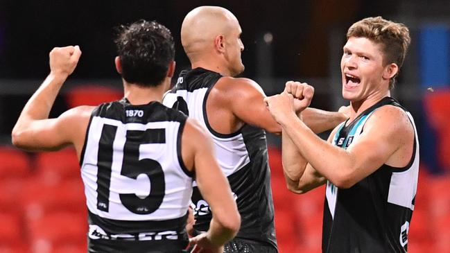 Mitch Georgiades celebrates with Karl Amon and Sam Powell-Pepper.