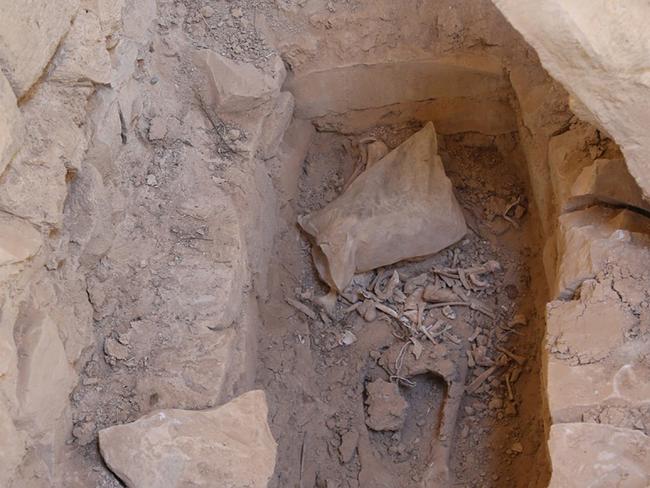 Without regard for history ... human remains at an open grave inside the destroyed Saint Eliane Monastery. Picture: Islamic State militant website via AP