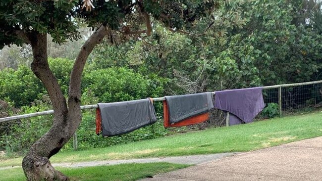 Homeless living at the popular North Burleigh beachfront on the Gold Coast - their blankets on the foreshore fence line.