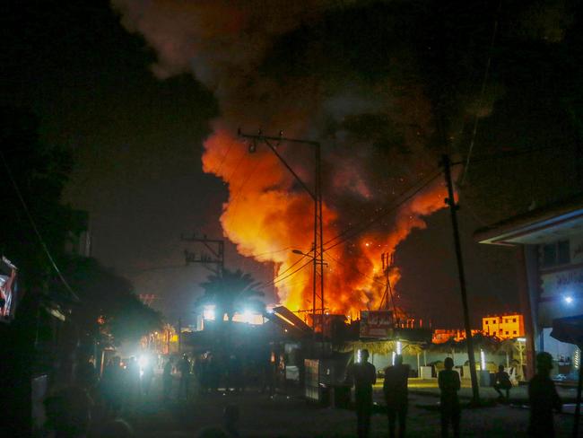 This handout picture provided by the United Nations Relief and Works Agency for Palestine Refugees in the Near East (UNRWA), shows fire and smoke billowing from the site of an Israeli air strike around tents for displaced people inside the walls of Al-Aqsa Martyrs Hospital in Deir al-Balah, in the central Gaza Strip early on October 14, 2024. (Photo by United Nations Relief and Works Agency for Palestine Refugees (UNRWA) / AFP) / === RESTRICTED TO EDITORIAL USE - MANDATORY CREDIT "AFP PHOTO / HO / UNRWA"- NO MARKETING NO ADVERTISING CAMPAIGNS - DISTRIBUTED AS A SERVICE TO CLIENTS ===